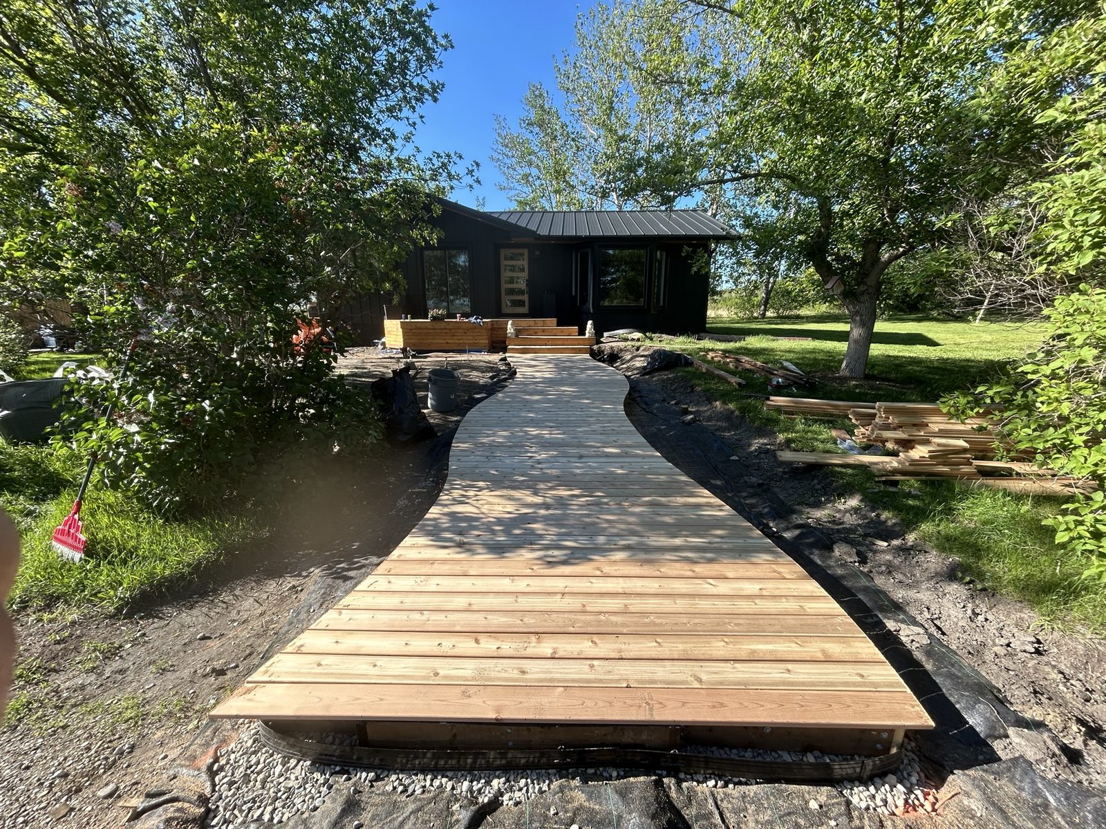 Winding wooden boardwalk framed by trees