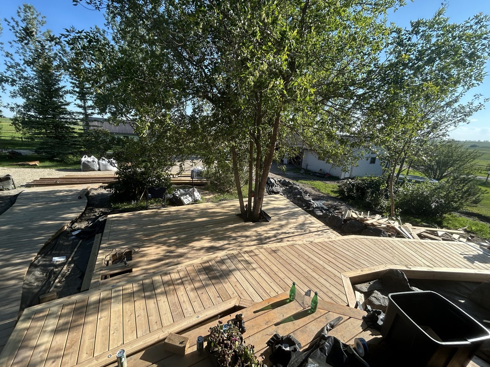 Finished wood deck built around a tree