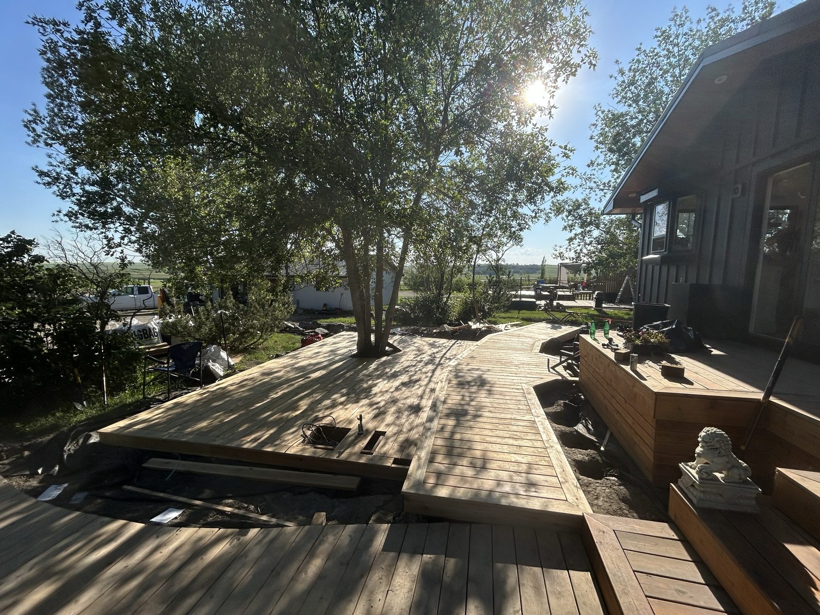 Completed deck and winding walkway with stone lion